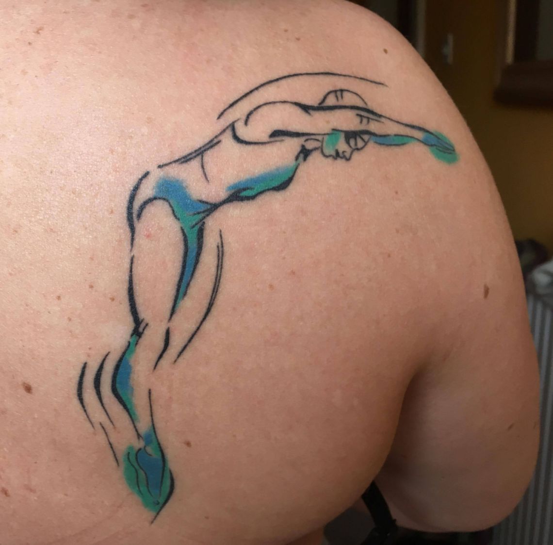 Emma's swimmer tattoo