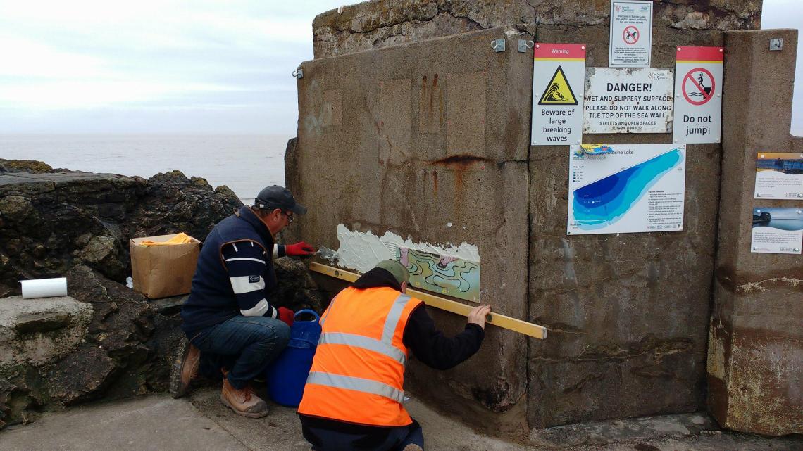 Swimmer tiles being installed on the pumphouse